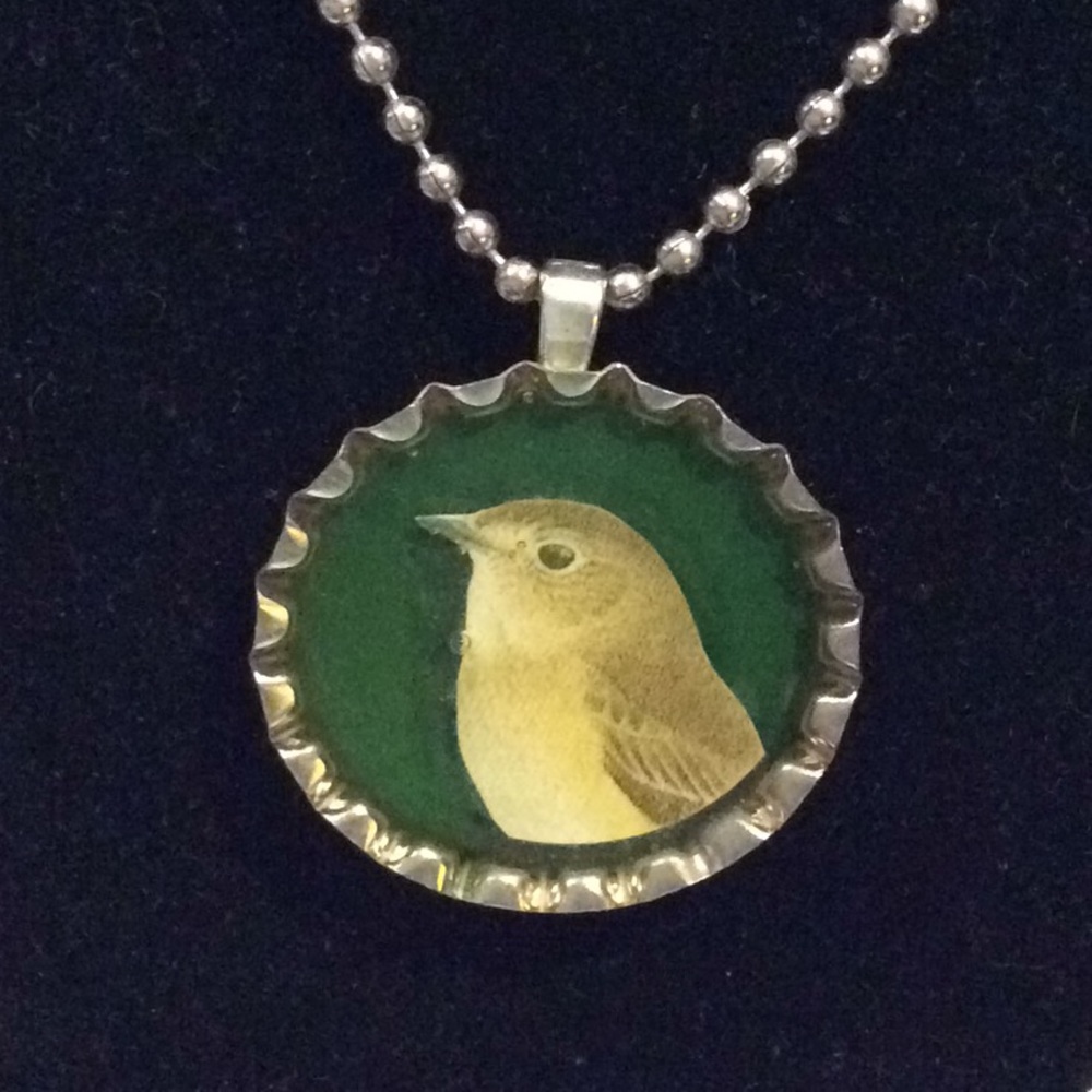 Handmade necklace with recycled bottle cap art.